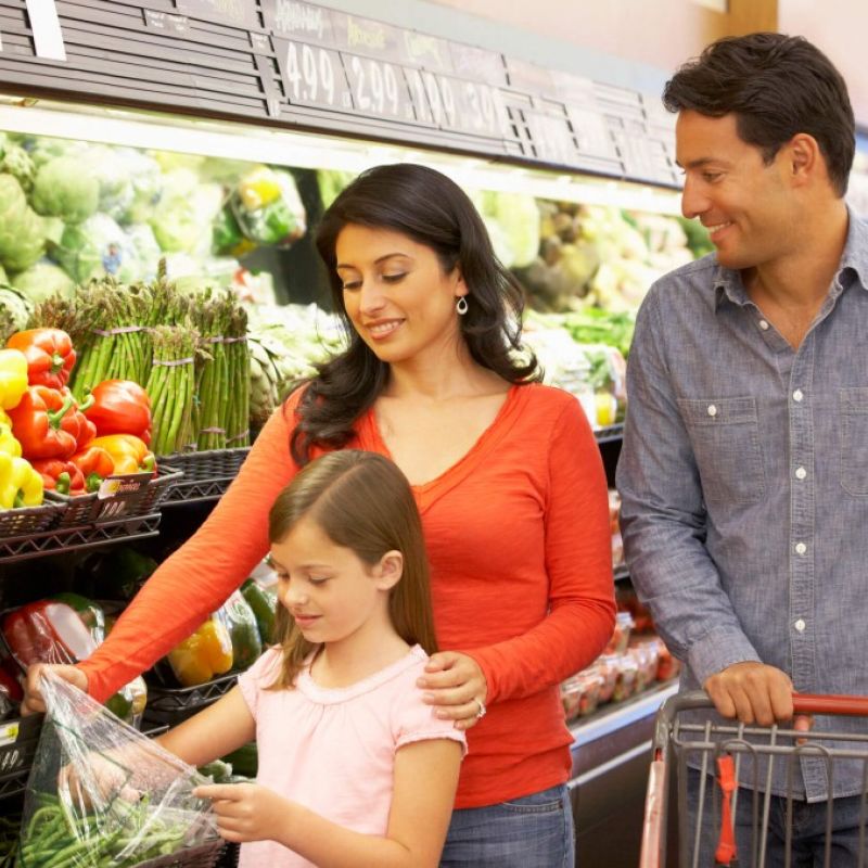 Parents and kid choosing vegetables