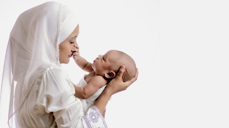 post pregnancy woman, holding her child