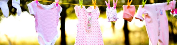 Baby clothes hanging on a line. 