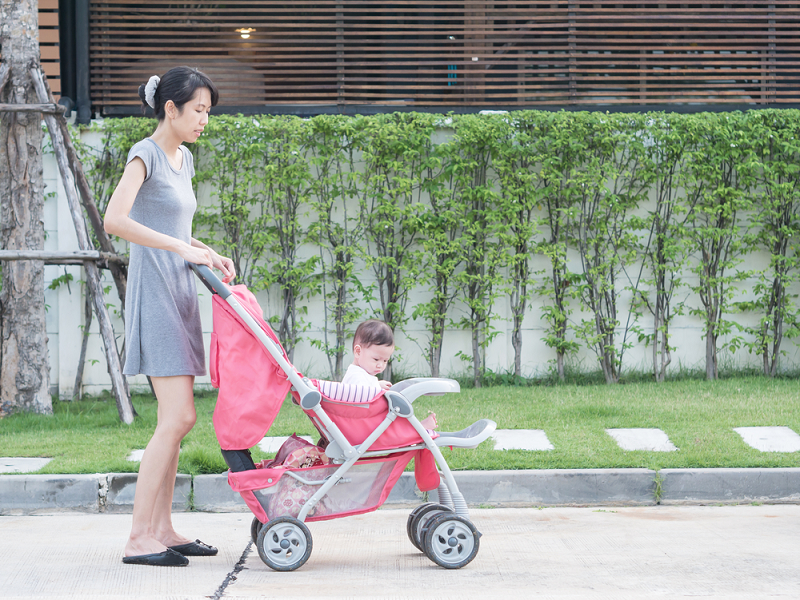 mother taking her crying baby for a walk