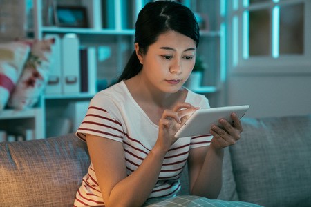 Woman Reading A Tablet