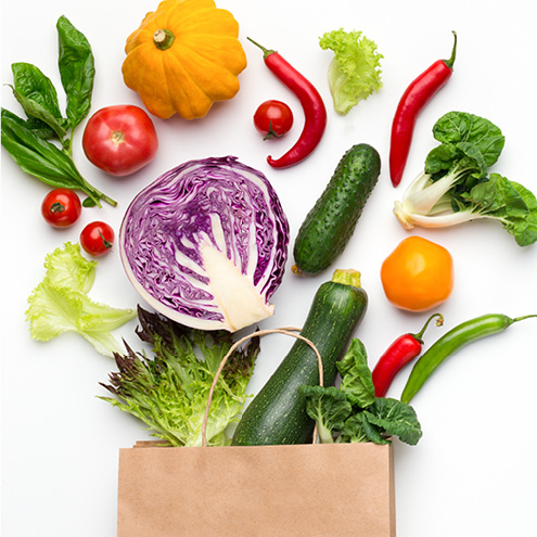 Vegetables Going Into A Bag