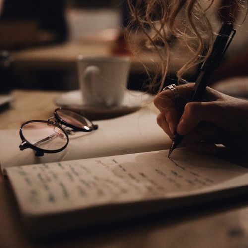 Person Writing with Coffee