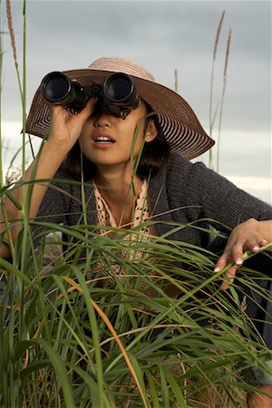 Woman Using Grass With Binoculars