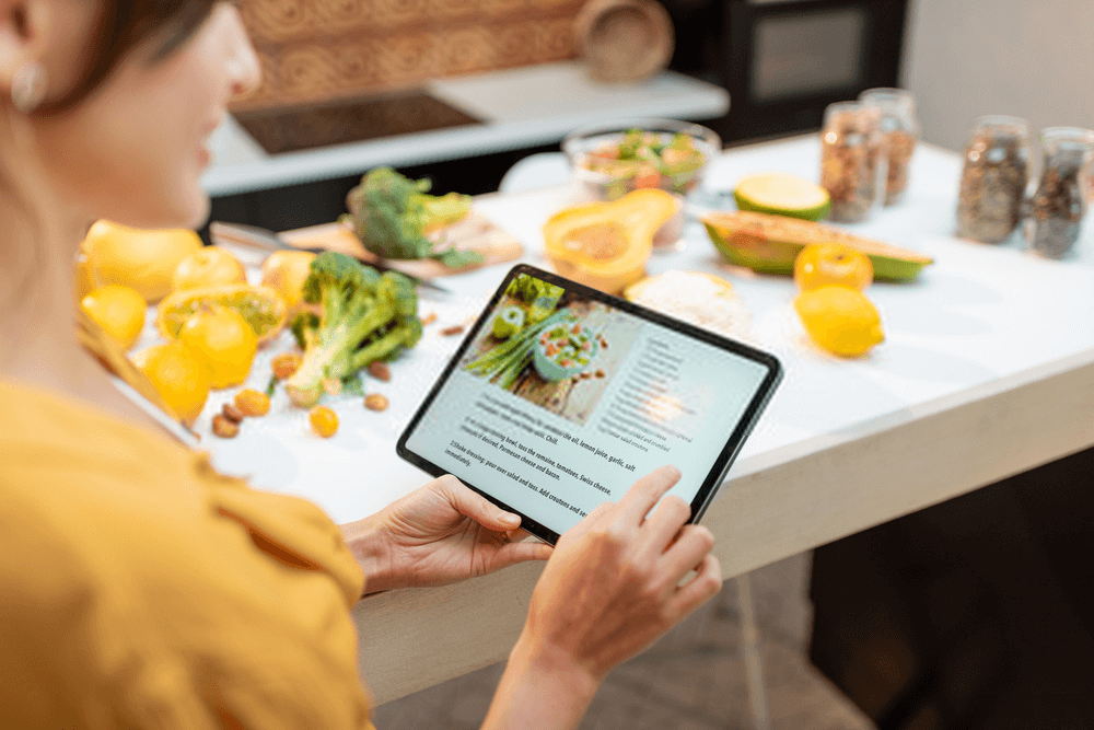 mother looking at tablet for home-cooked meals