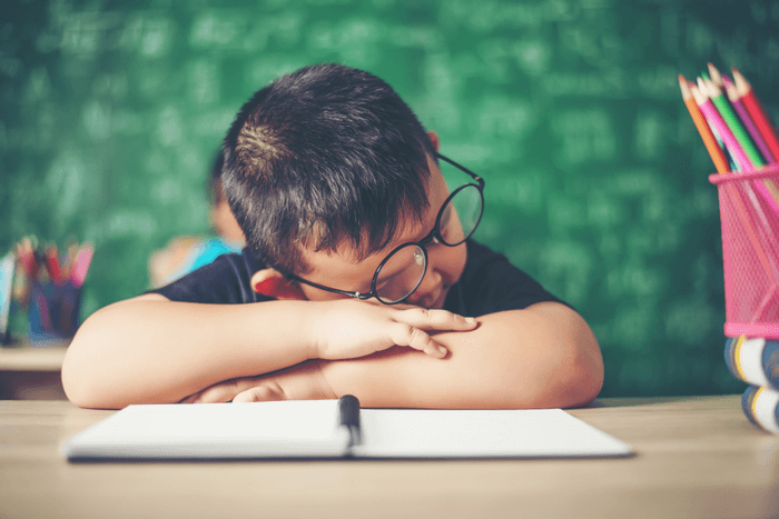 a boy sleeping on table