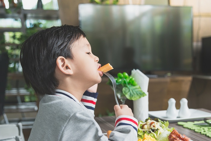 a boy eating good food for the immune system