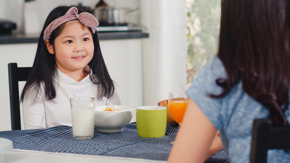 mother talking to daughter about the precautionary steps before going back to school