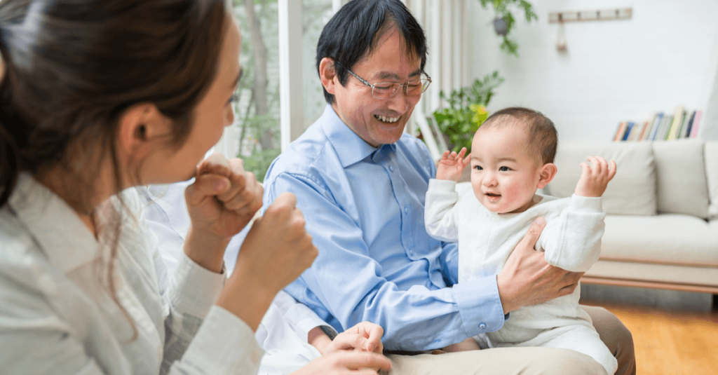 baby smile while sitting on her father