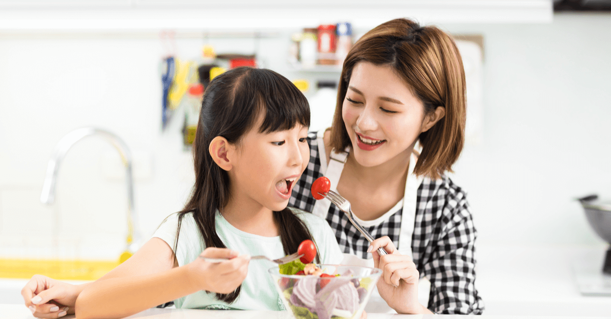 mother feeding her daughter, a picky eater