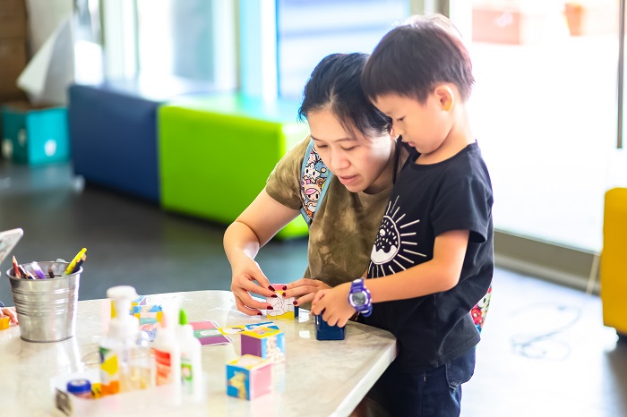 mother and son doing art with singapore tourism