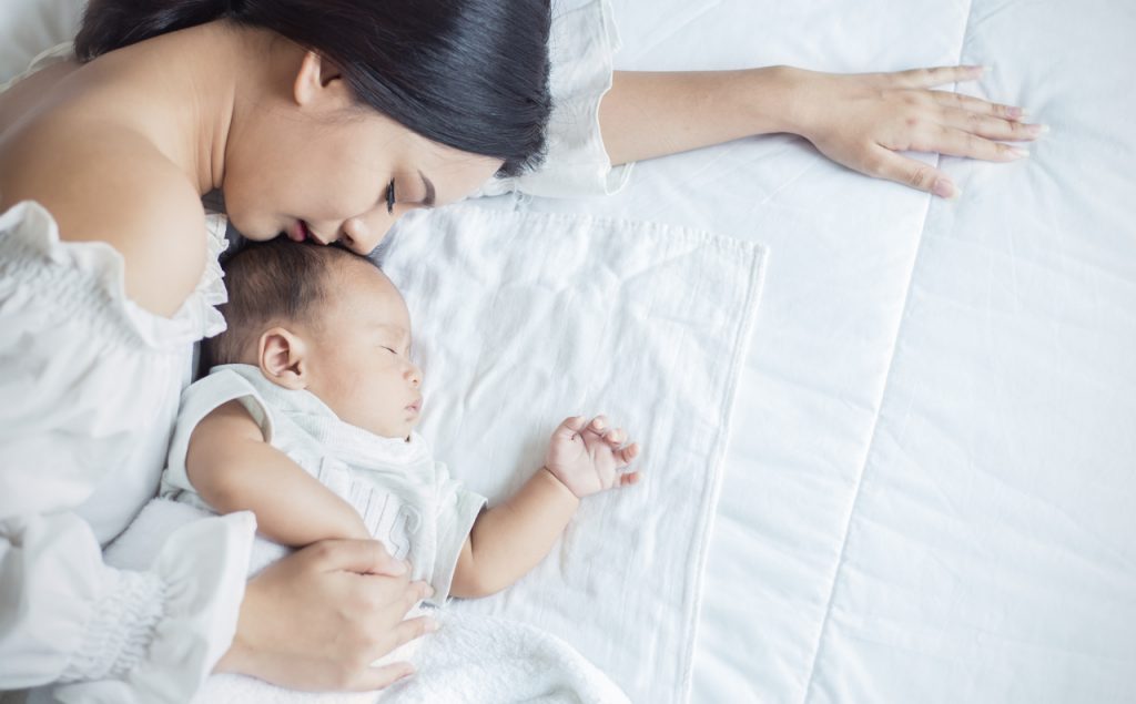 mother sleeping with baby