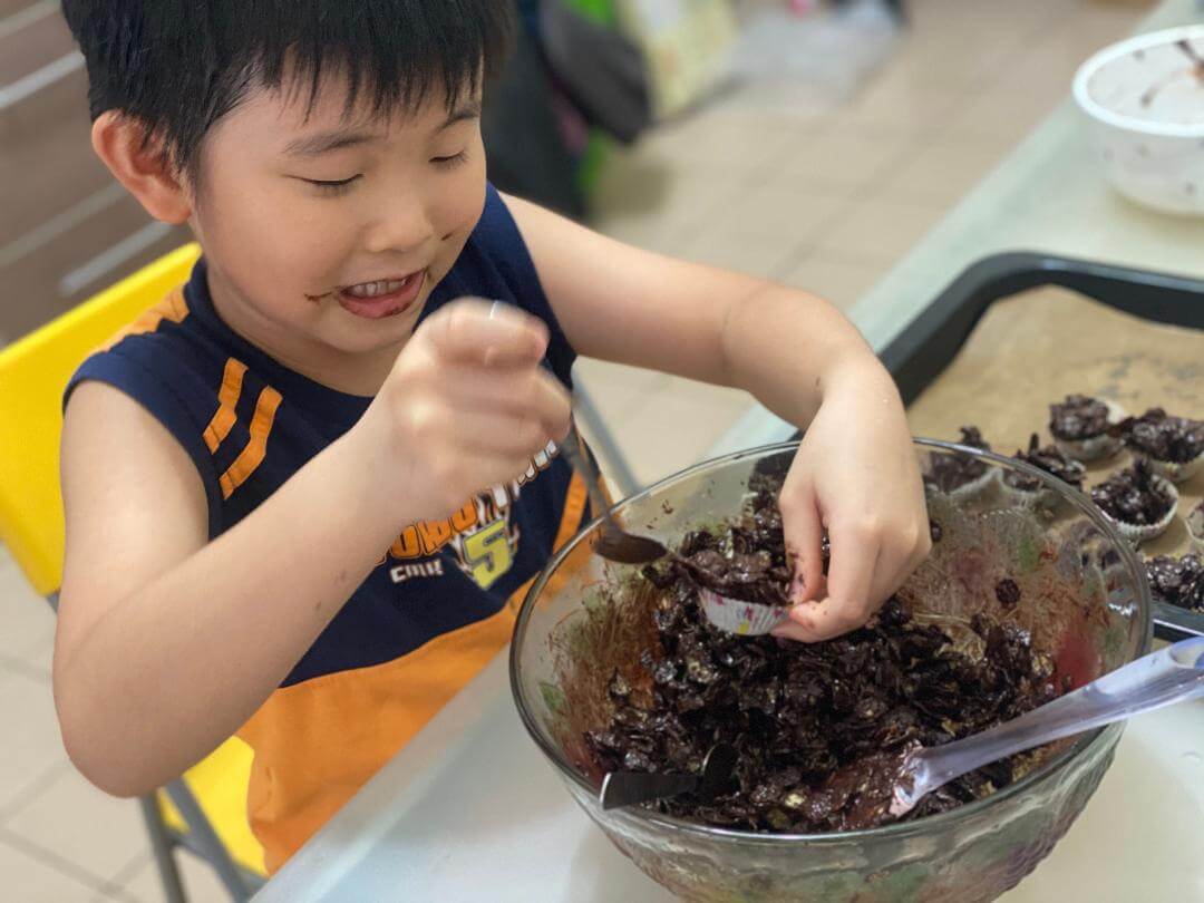 boy is preparing the Chocolate Cornflakes Clusters