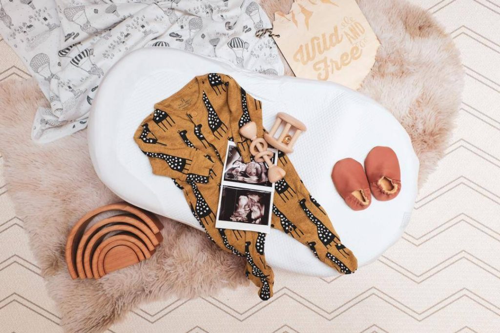 Ultrasound photos are seen with baby necessities.