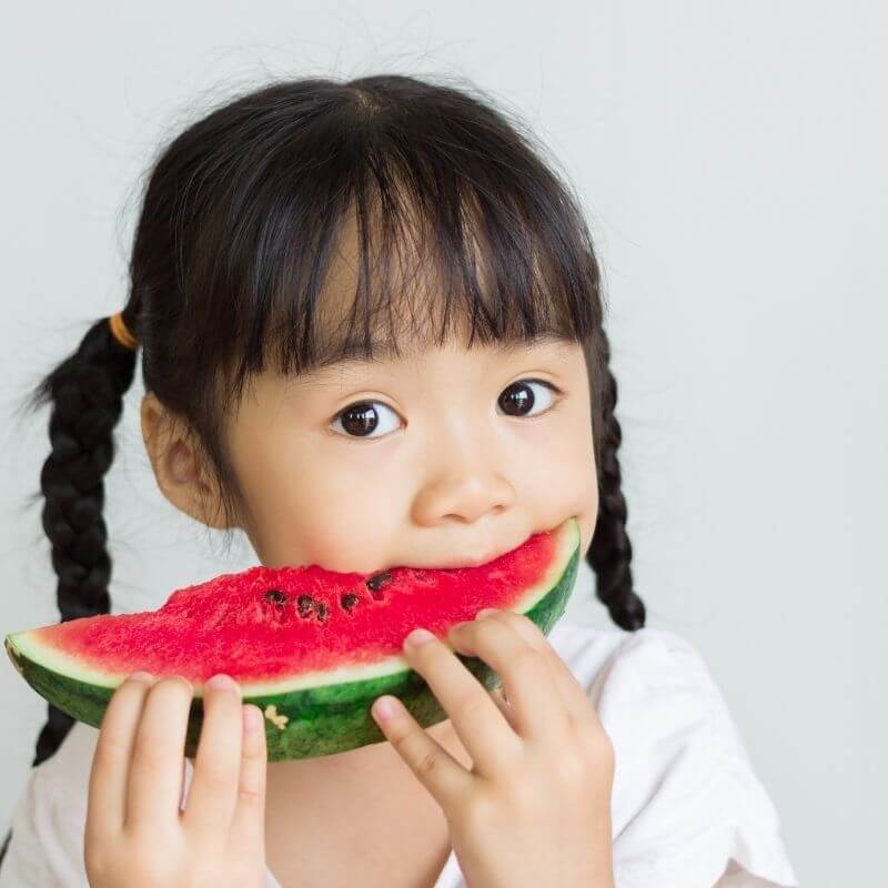 child eating fruit