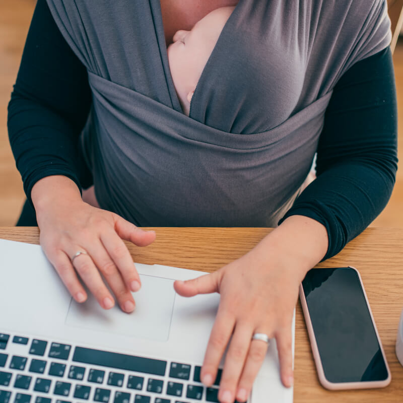 A mom working with a baby even on maternity leave