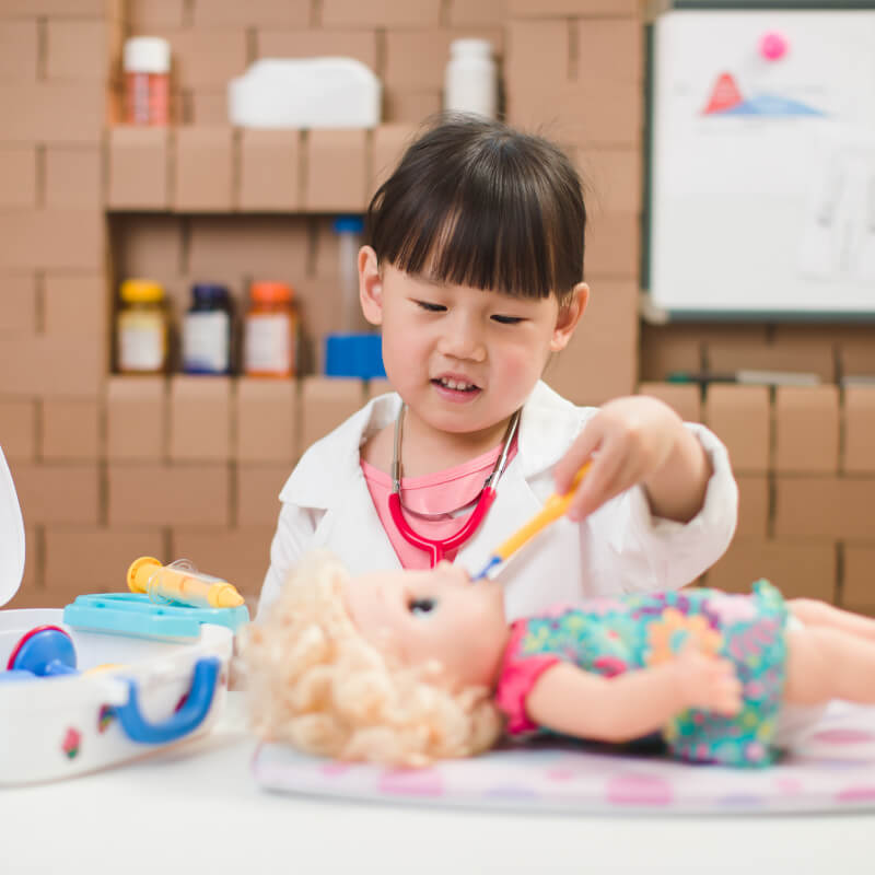 A toddler playing doctor