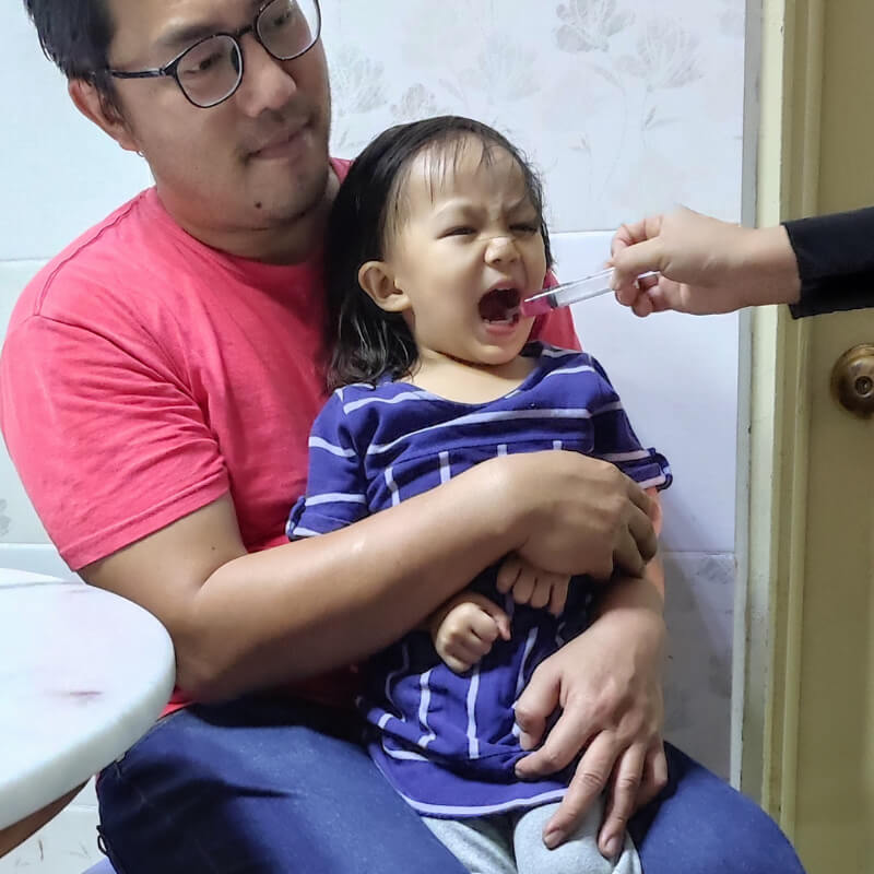 giving medicine to toddler