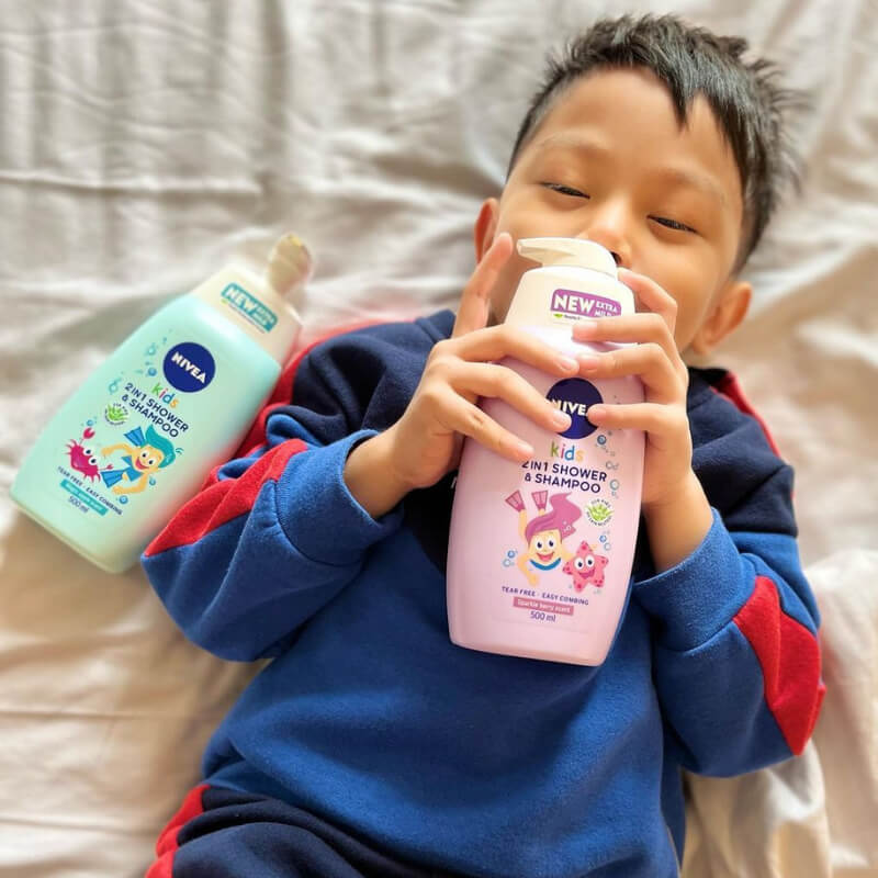 A boy holding Nivea Kids products