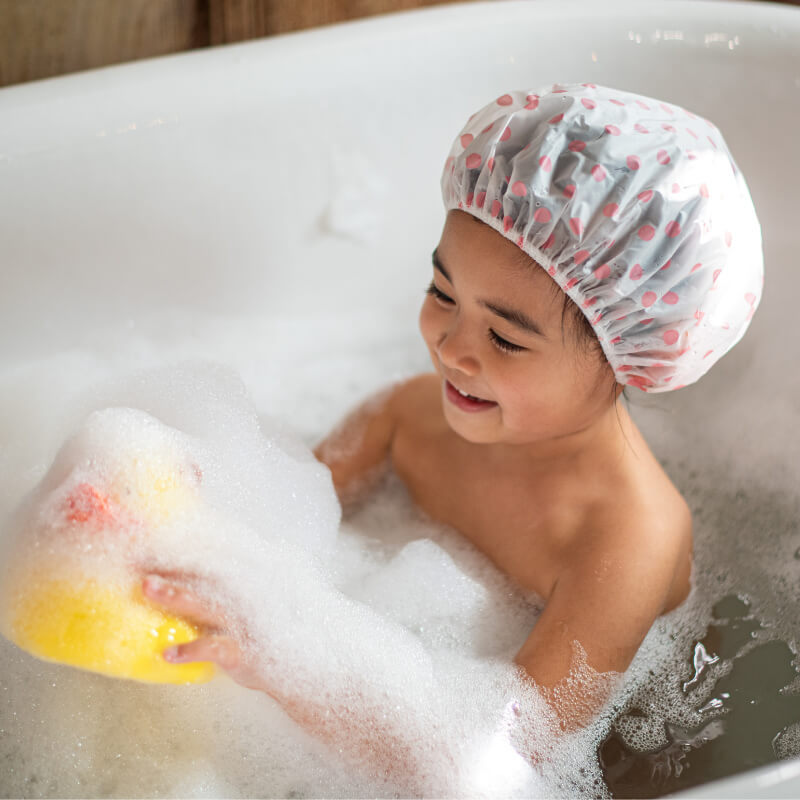 A girl playing in bath for body care