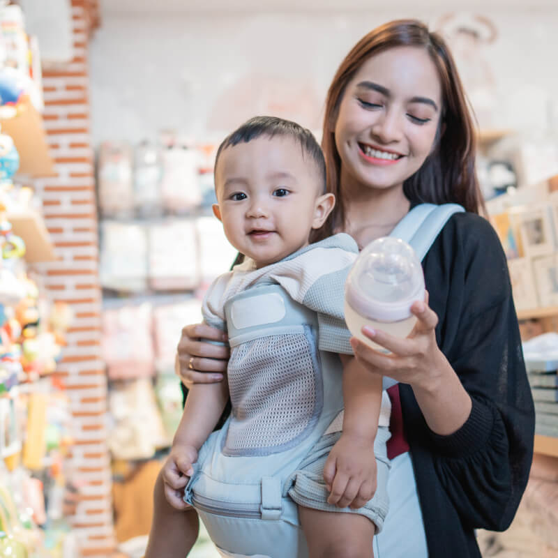 A mum buying a bottle for her baby