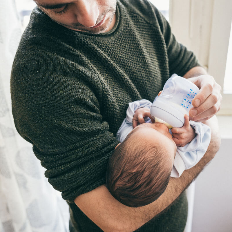 A dad feeding the baby