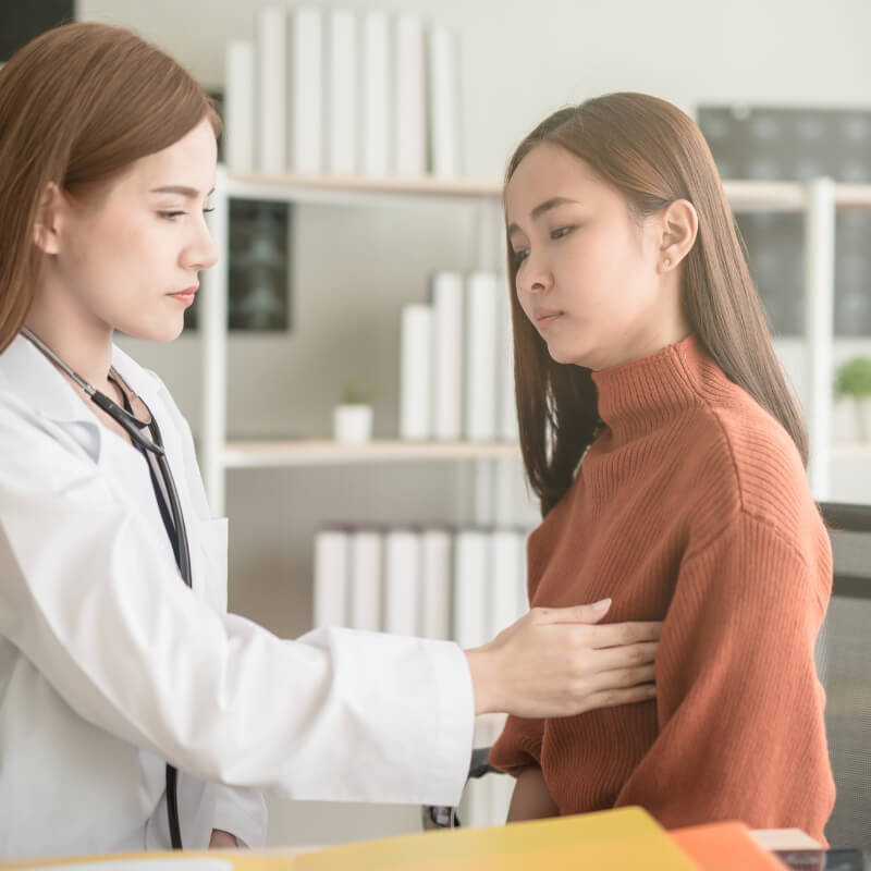 A doctor checking for breast lumps