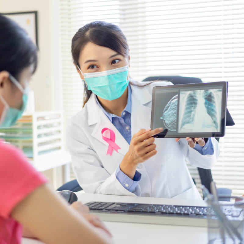 A doctor showing breast lumps on mammogram