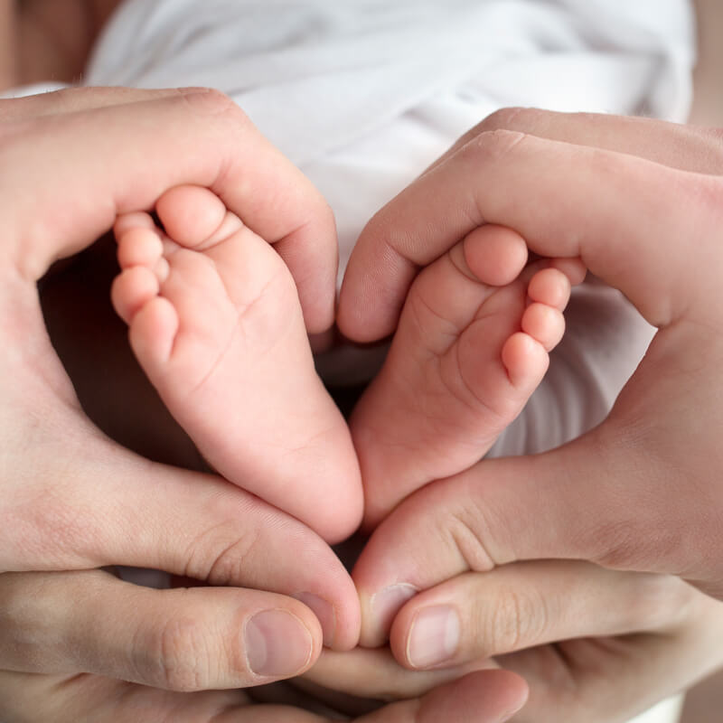 A family holding baby's feet