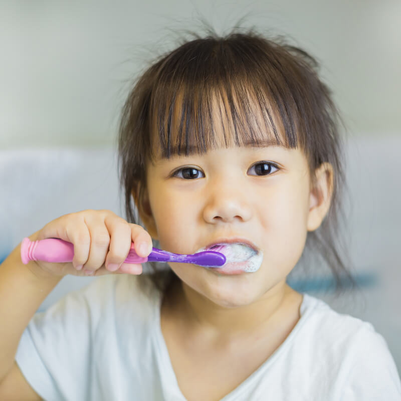 A girl brushing her teeth