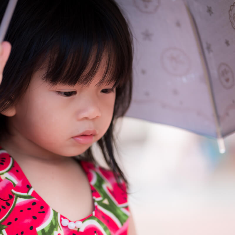 A girl sitting under shade for Malaysia Day