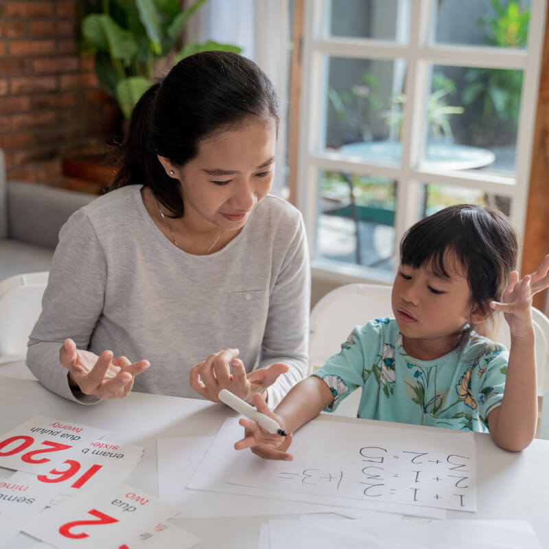 A mum helping daughter with homework