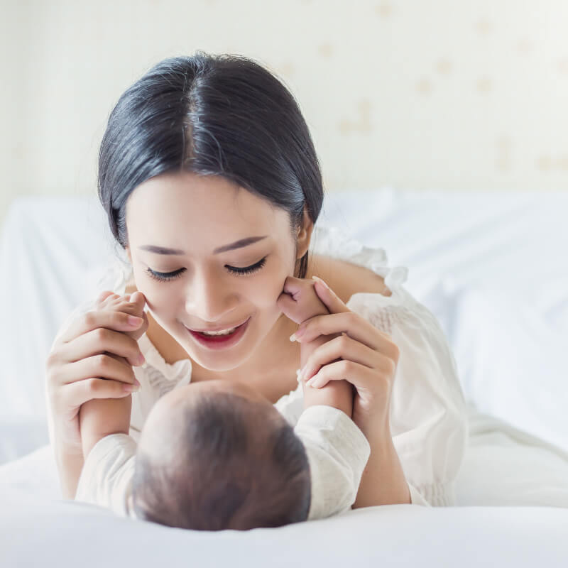 A mum playing with her baby