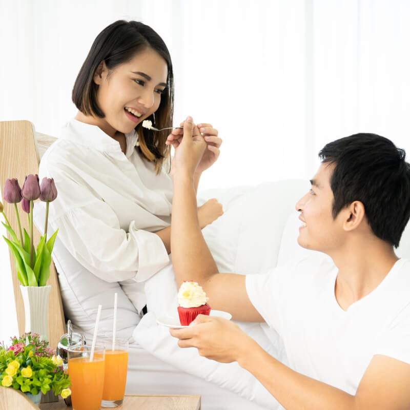 Husband feeding wife