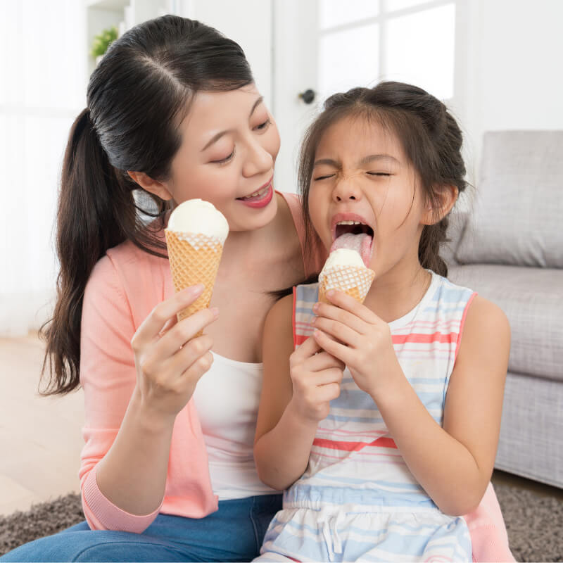 A girl eating ice cream to treat Tonsillitis