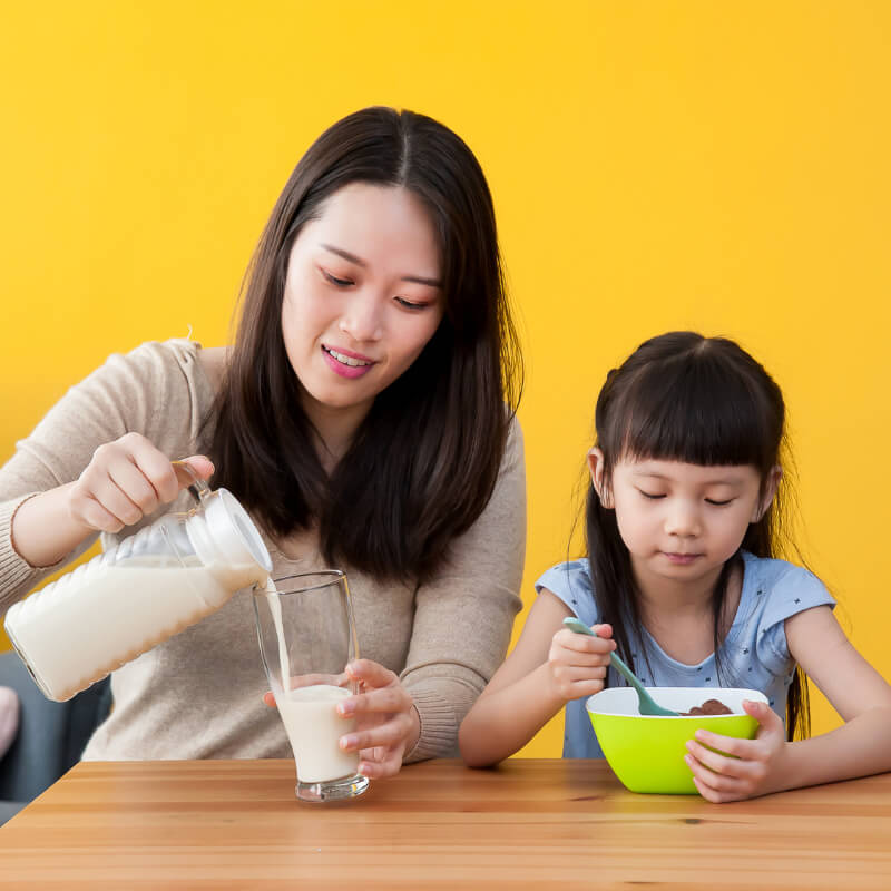 a mum pouring milk