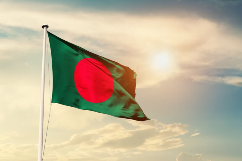 Bangladesh national flag cloth fabric waving on the sky with beautiful sun light 