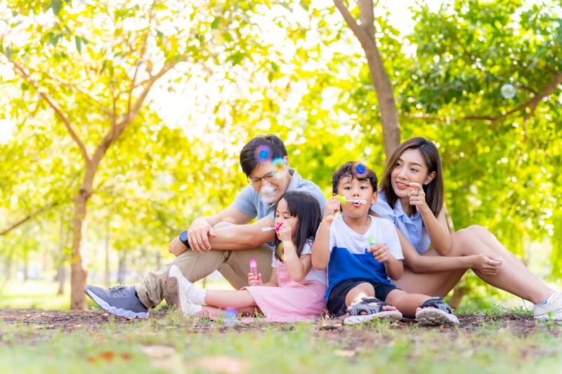 family playing bubbles outdoor