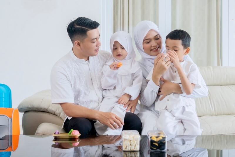 family eating snacks in the living room during eid mubarak celebration